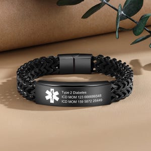 May include: Black medical alert bracelet with a stainless steel chain and a silver plate engraved with "Type 2 Diabetes", "ICD MOM 123 666686548", and "ICD MOM 159 5872 25449".