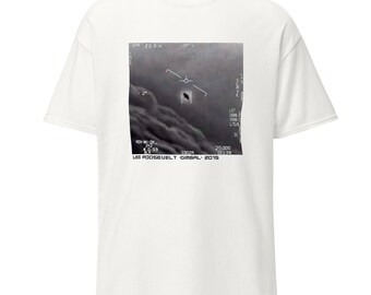 May include: A white t-shirt with a black and white image of a unidentified flying object (UFO) captured by a US Navy aircraft. The image is labeled "USS ROOSEVELT - GIMBAL - 2015".