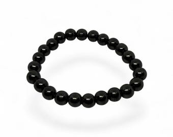 Pulsera elástica unisex de cuentas de hematita, color gris plomo metalizado intenso.