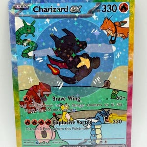 May include: A holographic Charizard ex trading card with 330 HP. The card features a central black Charizard illustration surrounded by smaller Pokémon characters, including a green snake, orange dragon, red creature, and blue Gyarados.