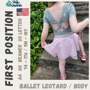 May include: A ballet leotard with a light pink skirt and a gray top with a heart-shaped back cutout. The top has a pattern of small white stars. The text "FIRST POSITION" and "BALLET LEOTARD / BODY" are visible.