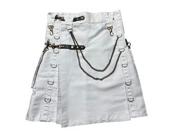 May include: White kilt with decorative metal hardware, including D-rings, chains, and clasps. The kilt features pleats and a leather belt detail. A unique garment for alternative fashion.