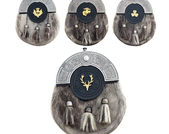 May include: Four traditional Scottish sporrans. Each sporran has a fur body, silver-toned metal detailing, and a different emblem: a thistle, a shamrock, a deer, and a military emblem. They feature decorative tassels.