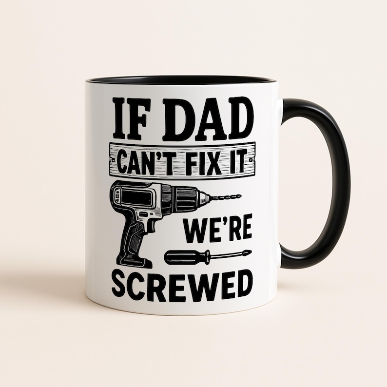 May include: White ceramic mug with a black interior and handle. The mug features the text "IF DAD CAN'T FIX IT WE'RE SCREWED" in black, with illustrations of a drill and screwdriver.