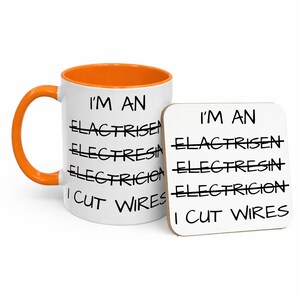 May include: A white ceramic mug with an orange interior and handle, paired with a square coaster. Both items feature the black text: I'M AN ELACTRISEN, ELECTRESIA, ELECTRICION, I CUT WIRES, with the first three words crossed out with black lines.