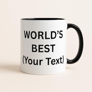 Op de afbeelding: Witte keramische mok met een zwarte binnenkant en handvat. De mok heeft de tekst "WORLD'S BEST (Your Text)" in vette zwarte letters, ideaal voor personalisatie. Een eenvoudig en klassiek ontwerp.