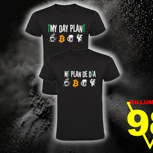 May include: Two black t-shirts with a white graphic design. The top shirt says "My Day Plan" and the bottom shirt says "Mi Plan de Dia". Both shirts feature a coffee cup, a Bitcoin symbol, a beer mug, and a person lifting weights.