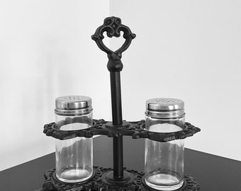 Elegant retro display in black cast iron for salt and pepper shakers