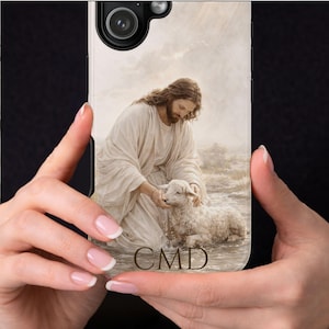 May include: A phone case featuring a religious image of a figure in white robes with long hair, kneeling and interacting with a lamb in water. The initials "CMD" are at the bottom. The background has a cloudy sky and light rays.