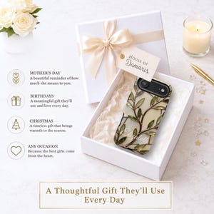 May include: A phone case featuring a stained glass-style pattern of green leaves and brown branches on a cream background, with the name Elizabeth printed in white script. The case is inside a white gift box with a ribbon and a House of Damaris tag.