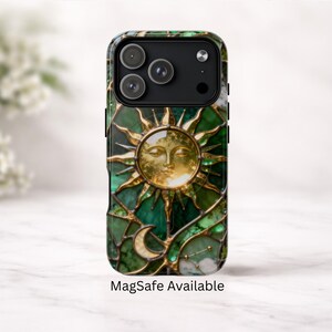 K&ouml;nnte beinhalten: Handyh&uuml;lle mit einem Buntglasdesign. Sie zeigt eine goldene Sonne, einen Mond und Sterne auf gr&uuml;nem Hintergrund. Das Geh&auml;use hat ein schwarzes Kameramodul und den Text "MagSafe Available".