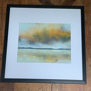 May include: A framed abstract painting of a landscape with a hazy sky in shades of yellow, orange, and gray. The sky is reflected in the water below, which is a light blue color. The painting is signed in the bottom right corner.