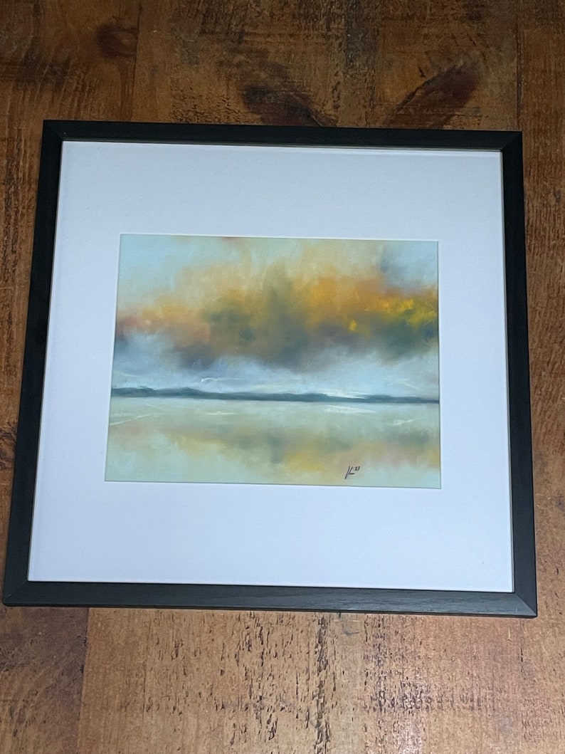 May include: A framed abstract painting of a landscape with a hazy sky in shades of yellow, orange, and gray. The sky is reflected in the water below, which is a light blue color. The painting is signed in the bottom right corner.