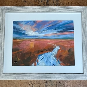 May include: A framed pastel painting of a landscape with a blue river flowing through a field of orange and pink hues under a dramatic sky with clouds in shades of blue, pink, and purple.