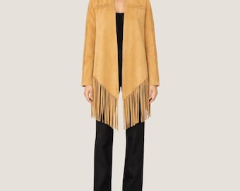 May include: A tan suede jacket with fringe detailing. The jacket has a draped open front and long sleeves with decorative stitching. The jacket is paired with black pants and sandals. The jacket is a stylish outerwear option.