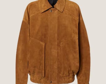 May include: A brown suede bomber jacket with a classic collar and two front pockets. The jacket has a button closure and ribbed cuffs and hem. The jacket is a medium weight and is suitable for fall or spring weather.