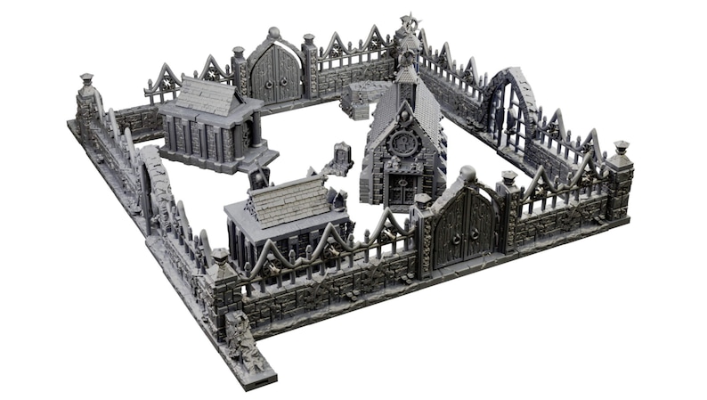 Op de afbeelding: Een grijze, steenachtige miniatuurbegraafplaatsset met een kerk, twee kleinere gebouwen, een poort en een hek. De set is gemaakt van plastic en is ontworpen voor tabletop gaming.