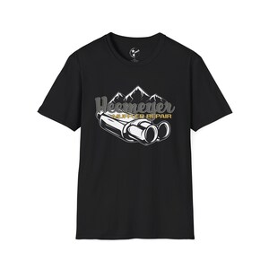 May include: Black t-shirt with a white graphic of a mountain range and two exhaust pipes. The text "Heemever Muffler Repair" is in gold lettering.
