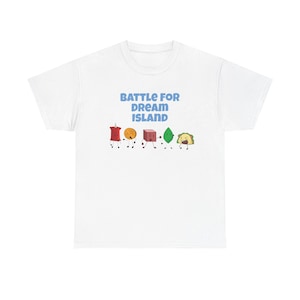 May include: White t-shirt featuring the text "BATTLE FOR DREAM ISLAND" in blue, above cartoon characters. The characters include a red pushpin, a yellow coin, a brown cube, a green leaf, and a yellow taco.