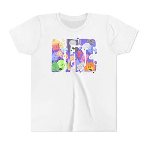 May include: White t-shirt featuring a colorful graphic design. The design spells out "BFDI" with various cartoon characters in shades of yellow, blue, green, and orange. The shirt has a crew neck and short sleeves.