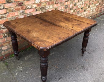 Antique Victorian solid mahogany dining table with castor wheels