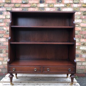 Regency style Vintage mahogany waterfall bookcase with drawers and castor wheels