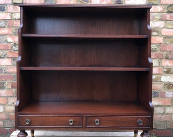 Regency style Vintage mahogany waterfall bookcase with drawers and castor wheels