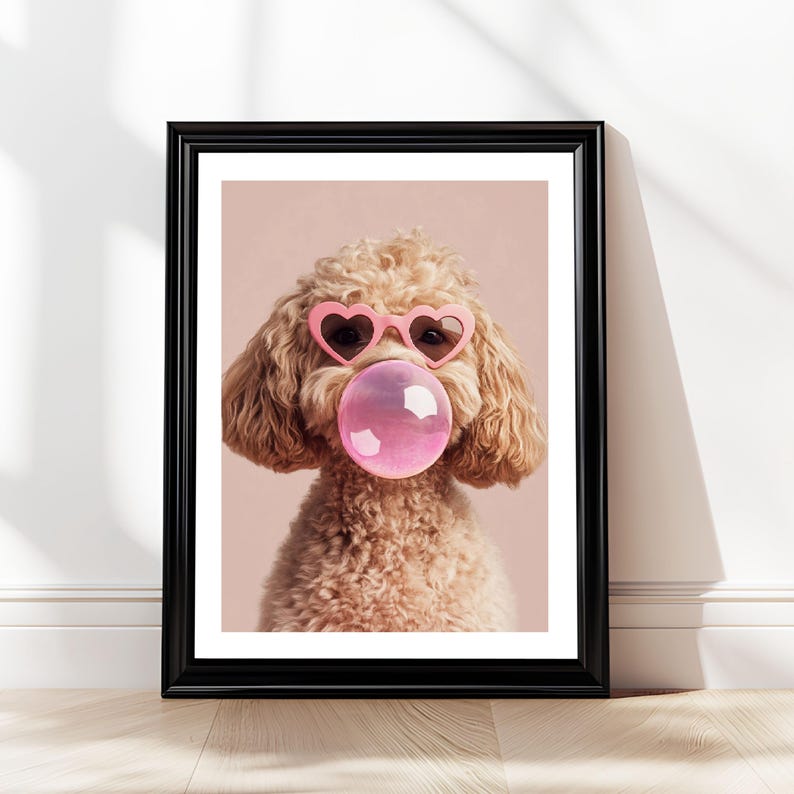 May include: A light brown poodle wearing pink heart-shaped sunglasses and blowing a pink bubble. The dog is looking directly at the camera.