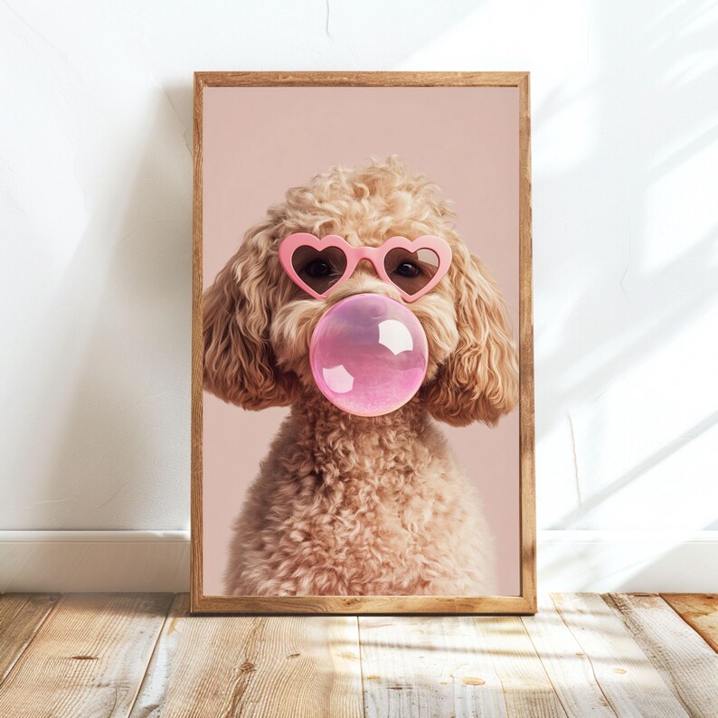 May include: A light brown poodle wearing pink heart-shaped sunglasses and blowing a pink bubble. The dog is looking directly at the camera.