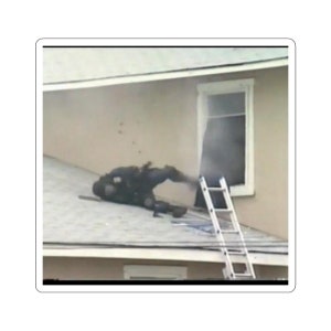 May include: A person in black tactical gear falls from a window onto a roof, with a ladder leaning against the side of the building.