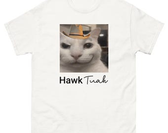 May include: White cat wearing a brown cowboy hat with the text "Hawk Tuah" printed below the image.