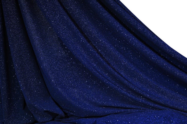 a close-up view of a dark blue fabric with a glittery texture, creating a shiny and sparkly appearance.