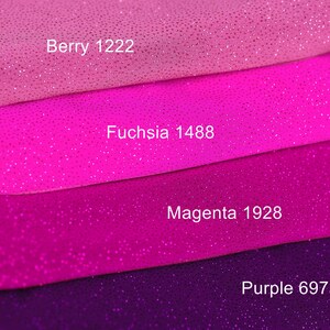 a close-up of a pile of fabric with different colors, including pink, purple, and purple.