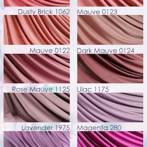 a collection of fabric swatches in various shades of pink, ranging from dusty rose to lavender, with some shades appearing darker or more muted.
