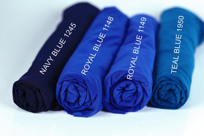 four rolled-up blue shirts, each with a different color label indicating the color: navy blue, royal blue, teal blue, and turquoise.