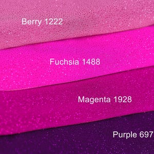 a close-up of a pile of fabric with different colors, including pink, purple, and purple.
