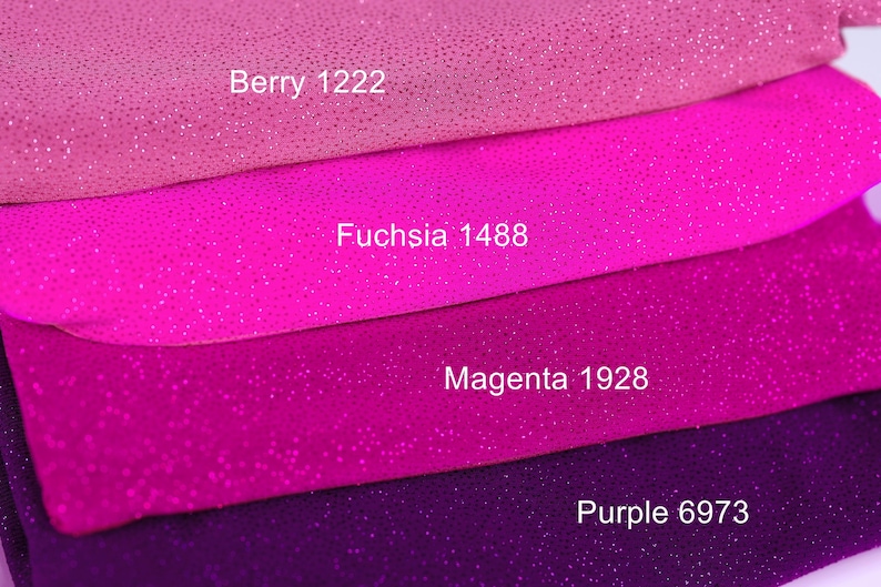 a close-up of a pile of fabric with different colors, including pink, purple, and purple.