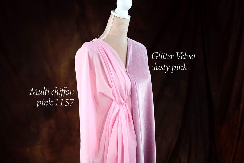 A mannequin wearing a pink chiffon dress with a metallic sheen, set against a dark background.