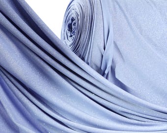 May include: A roll of light blue fabric with a subtle glitter effect. The fabric is draped, revealing folds and textures. The material appears soft and flowing, with a slight sheen. The background is white.