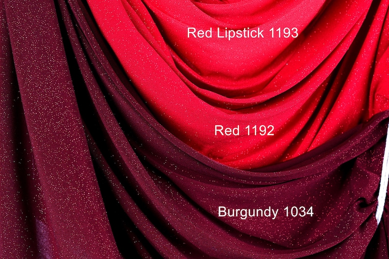 a close-up view of a fabric with red and burgundy colors, with the red fabric appearing to be a red lipstick shade and the burgundy fabric being a burgundy fabric.