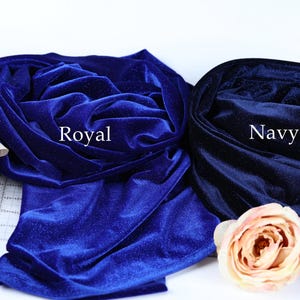 two fabric swatches, one royal blue and one navy blue, with a pink rose on the left side.