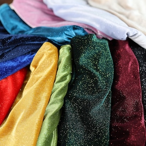 a pile of different colored cloths sitting on top of each other