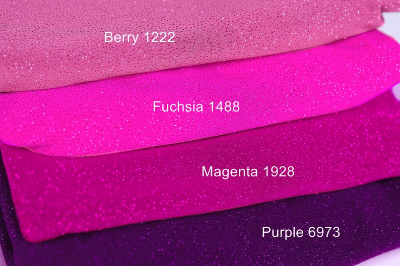 a close-up of a pile of fabric with different colors, including pink, purple, and purple.
