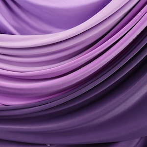 a close-up view of a fabric with a gradient of purple and pink colors, creating a visually appealing and textured appearance.