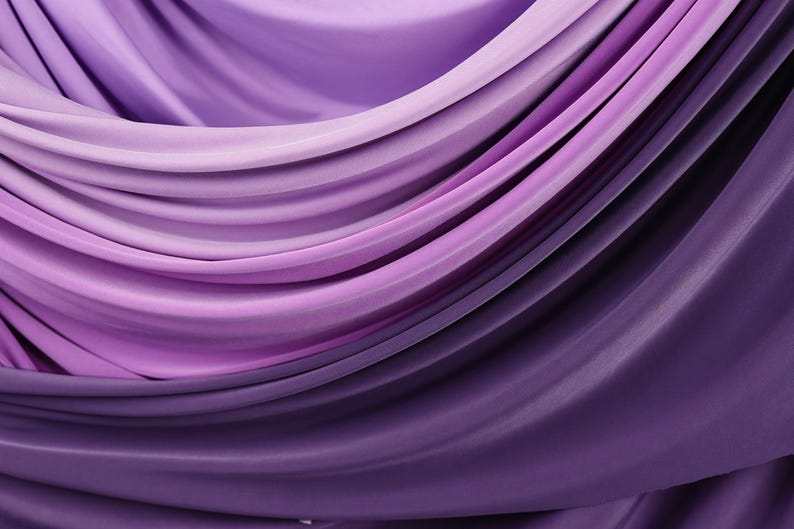 a close-up view of a fabric with a gradient of purple and pink colors, creating a visually appealing and textured appearance.