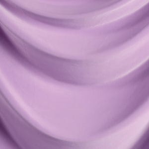 The image is a close-up of a soft, flowing purple fabric, possibly a curtain or garment. The fabric has a smooth, shiny texture and is draped in a way that creates a sense of movement and depth.