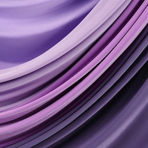 a close-up view of a fabric with a gradient of purple and pink colors, creating a visually appealing and textured appearance.