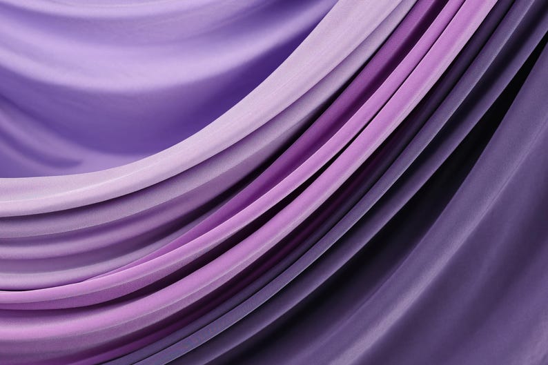 a close-up view of a fabric with a gradient of purple and pink colors, creating a visually appealing and textured appearance.
