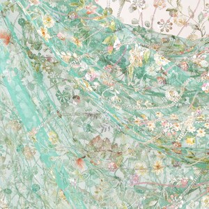 The image is a close-up of a fabric with a floral pattern, featuring a variety of colors and textures.