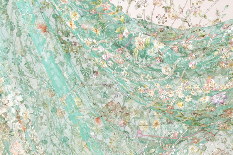 The image is a close-up of a fabric with a floral pattern, featuring a variety of colors and textures.